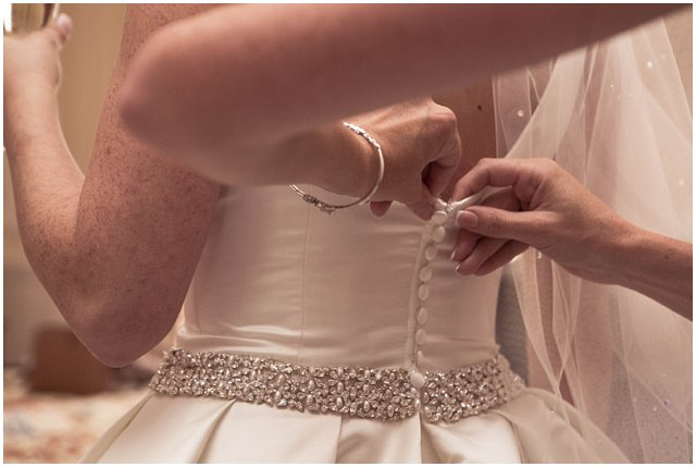 Bride getting dressed on wedding day