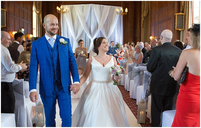 bride and groom recessional at tylney hall wedding by hampshire wedding photographer