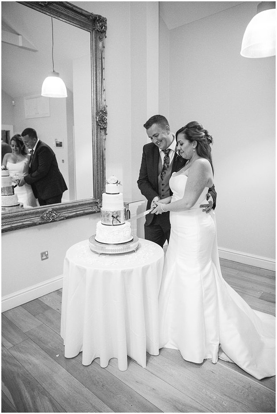 bride and groom cutting cake at Wasing Park