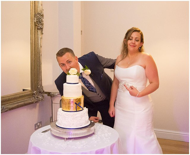 bride and groom cutting cake at Wasing Park