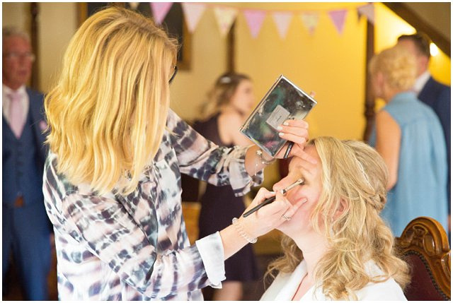 bride getting her makeup done at Lainston House