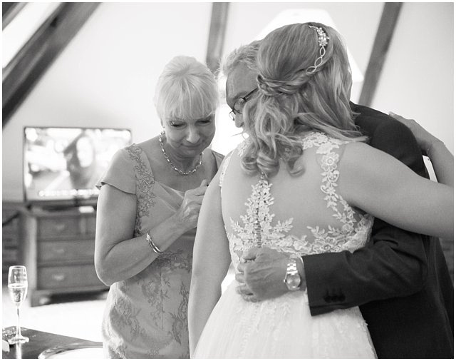 emotional moment between bride and family on wedding day