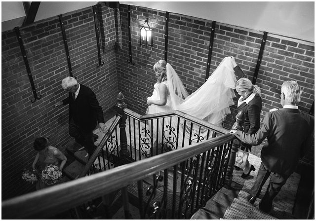 bride walking to ceremony with family and bridesmaids