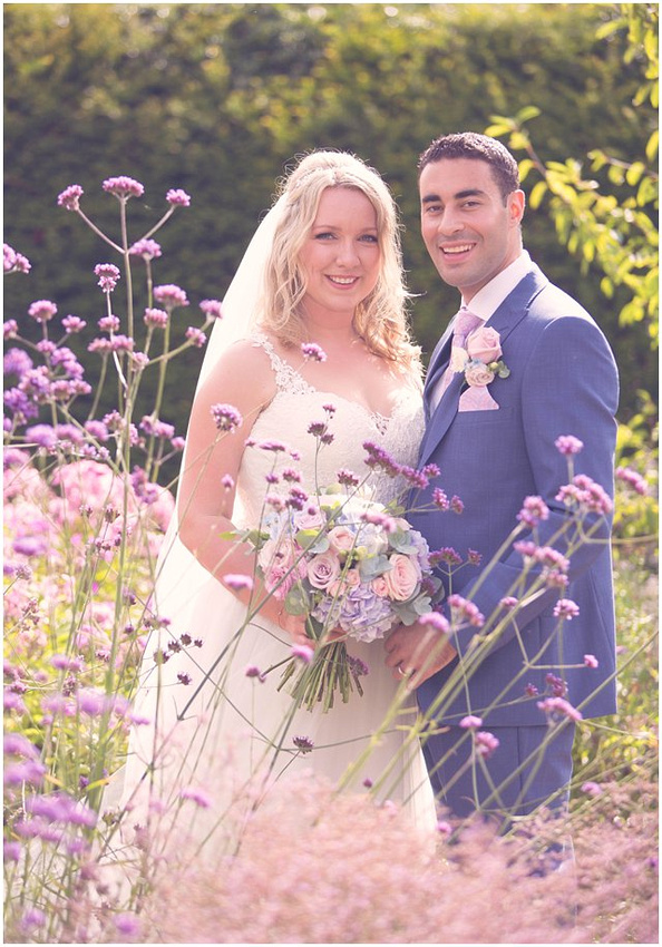 photo of bride and groom smiling at the camera