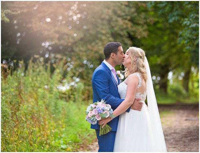 groom kissing his bride on their wedding day