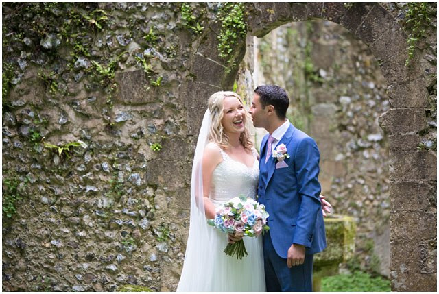 candid photo of bride laughing with her groom on their wedding day