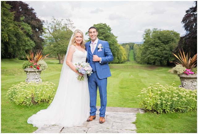 formal wedding portrait of bride and groom in an elegant garden