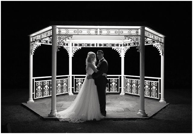 romantic night photo of bride and groom in a gazebo