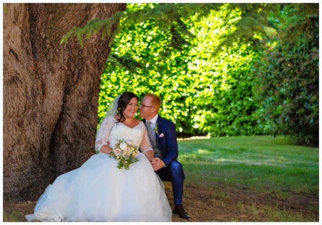 formal photo of bride and groom in gardens at Hampden House