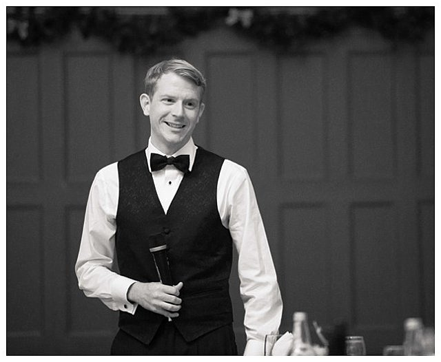 candid photo of groom toasting at wedding reception at Bingham Hall