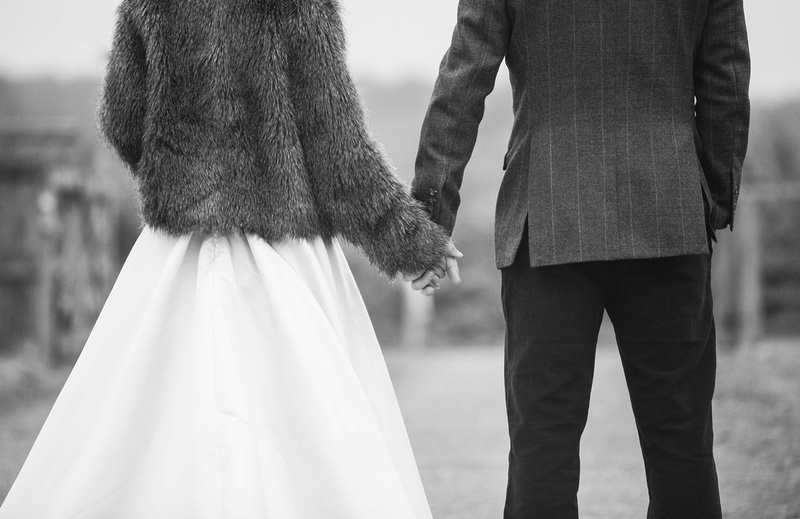 mono wedding couple holding hands