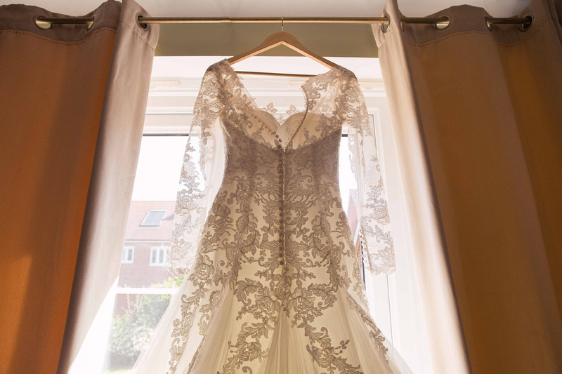 lace wedding dress hanging up